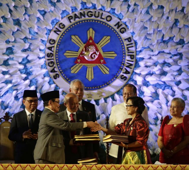 DEAL IN PERIL? President Benigno Aquino III and Malaysian Prime Minister Najib Razak witness the exchange of documents following the signing of a final peace agreement between the Philippine government and the MILF on March 27, 2014. Photo by Dennis Sabangan/EPA  