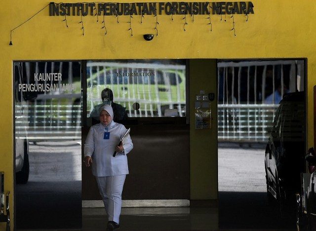 TES. Seorang pejabat forensik Malaysia berjalan keluar dari ruang forensik di Rumah Sakit Kuala Lumpur pada 16 Februari 2017, di mana jasad Kim Jong-Nam, kakak tiri pemimpin Korut, Kim Jong-Un disemayamkan. Foto oleh Manan Vatasyayana/AFP 