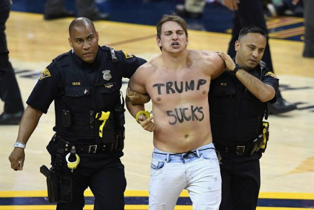 Shirtless fan with ‘Trump sucks’ on torso storms court in Game 4