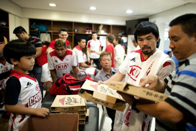 The Pacman plays pizza man in the KIA locker room. Photo by Noel Celis/AFP 
