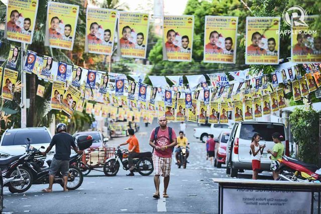 CAMPAIGN SEASON. In this file photo during the 2016 elections, a man walks past campaign banners of local politicians at Fairview in Quezon City. File photo by Martin San Diego/Rappler 