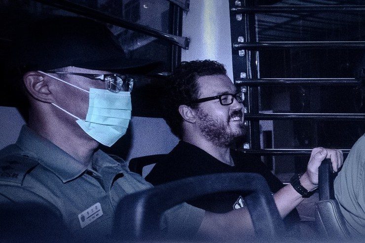 UK banker on double murder charge grins leaving HK court