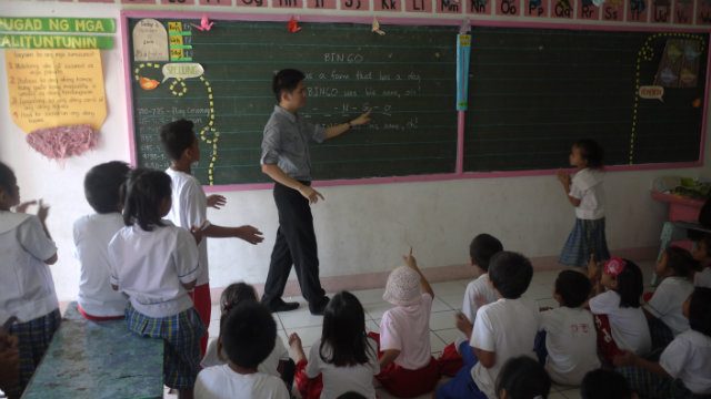 CHALK TALK. Emerald Ocado teaches English through a popular children's song at the Malaban Elementary School. 