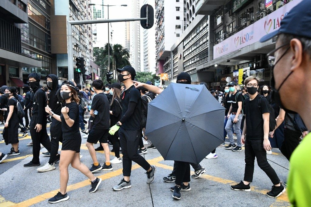 Tear gas, water cannons as marchers defy police in Hong Kong demonstrations