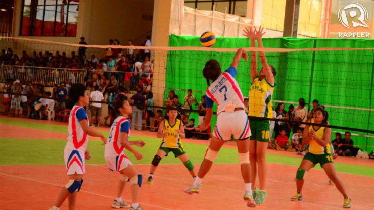 A Bicol secondary girls volleyball player knocks the ball past the defense of an ARMM player. Photo by Jerome Monta/Rappler