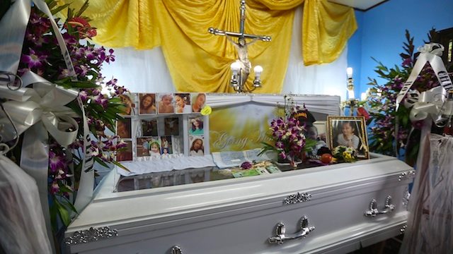 SLAIN TEEN. Photos of the teenager are placed on top of Charlie Jean Du's casket 