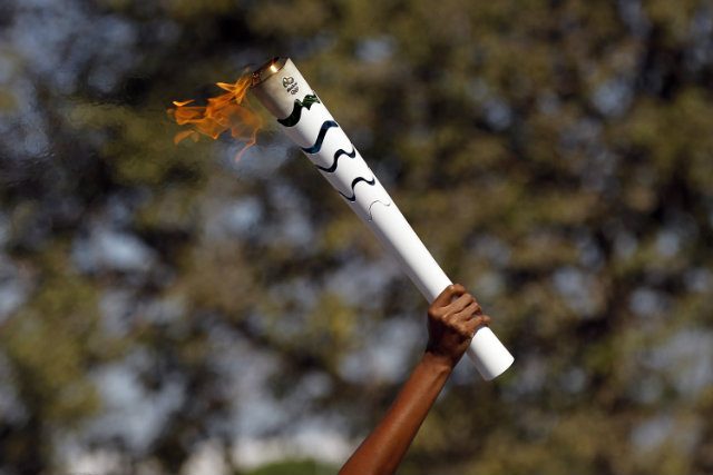 Protesters interrupt Olympic torch relay, attempt to extinguish flame