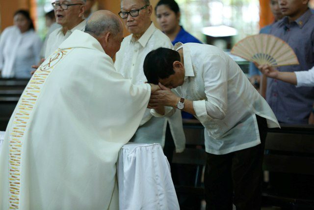 MANO PO. President Rodrigo Duterte (right) greets Davao Archbishop Romulo Valles (left) during the 50th wedding anniversary rite of Undersecretary Jesus Melchor Quitain and his wife Anita at St Francis of Assisi Parish in Davao City on August 27, 2016. MalacaÃ±ang file photo  