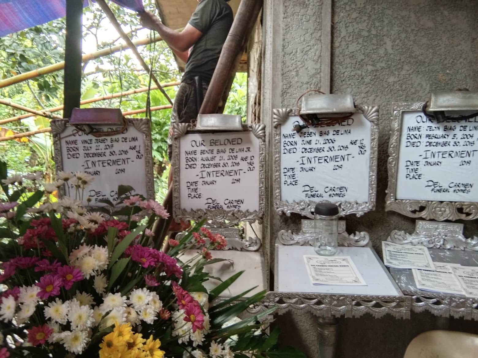GRIEF. Four wake announcement boards welcome mourners at a house in San Vicente, Baao, Camarines Sur. Photo courtesy of Philippine Red Cross-CamSur  