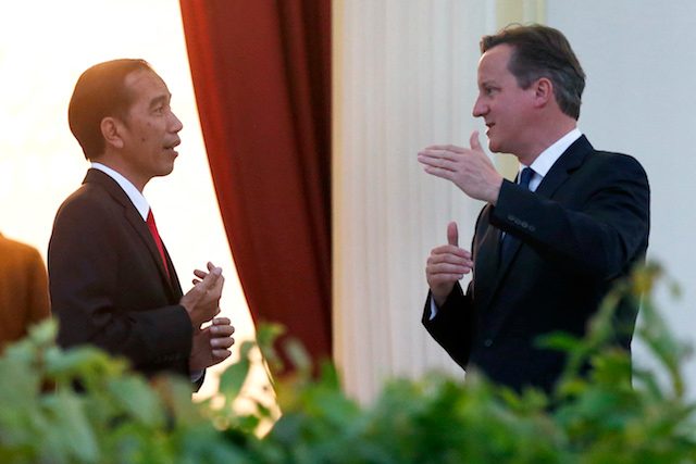 Presiden Indonesia Joko Widodo dan PM Inggris David Cameron berbincang-bincang di Istana Presiden, 27 Juli. Cameron mengunjungi Indonesia untuk meningkatkan kerja sama ekonomi antara kedua negara. Foto oleh Mast Irham/EPA 