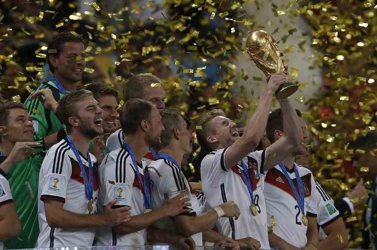 André Schürrle holds the trophy as he celebrates with his teammates after their World Cup final victory. Photo by Adrian Dennis/AFP