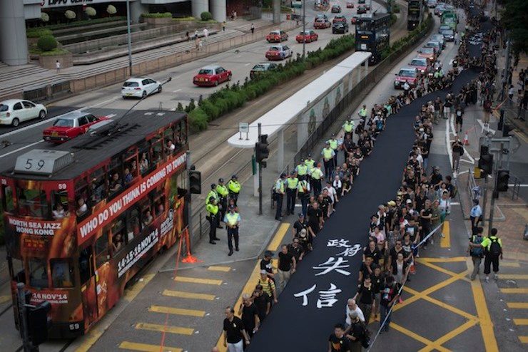 Black-clad democracy activists stage somber Hong Kong rally