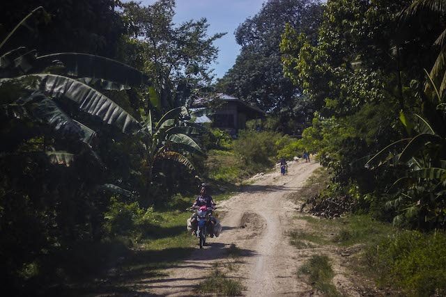 LIFE GOES ON. A dirt road in the town of Aleosan in North Cotabato.