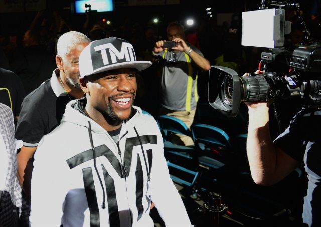 Floyd Mayweather smiles for the cameras as he makes his entrance. Photo by Michael Nelson/EPA 