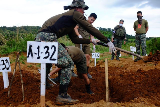 EXHUMATION. Marines from the 7th Marine Landing Battalion Team (MLBT) exhume a grave thought to contain the remains of Marine Private Alejandro Balean. Photo by Bobby Lagsa/Rappler 