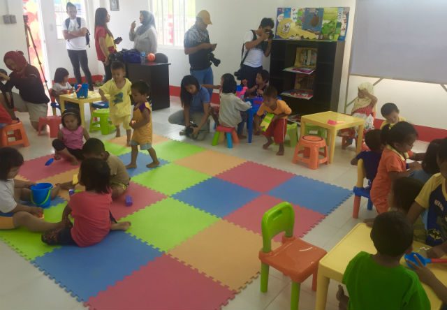 PLAYTIME. Children from the Barangay Sagonsongan relocation site play in the McDonalds Bahay Bulilit child center. 