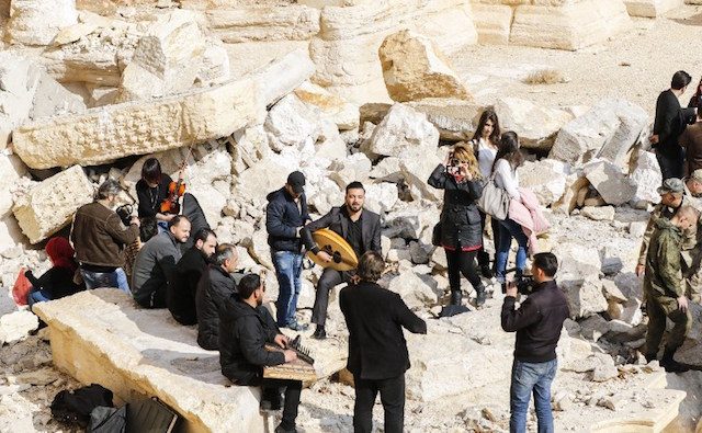 Atop Palmyra’s damaged theater, Syrian musicians sing of return