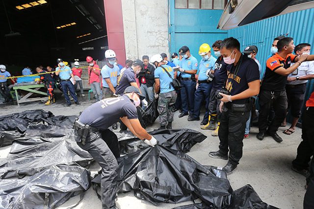 FATALITIES. Authorities seal the remains of workers killed in a footwear factory in Valenzuela. Photo by PNP-PIO 