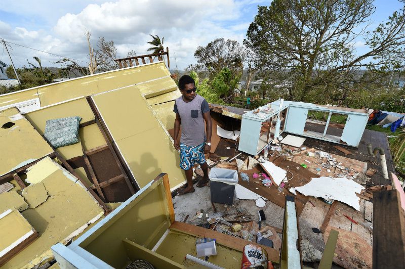 AFTER THE DISASTER. Adrian Banga surveys his destroyed house in Port Villa, capital of Vanuatu, 16 March 2015. Photo by Dave Hunt Australia and New Zealand Out/EPA  
