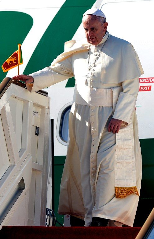 OFF THE PLANE. Pope Francis disembarks from an airplane after arriving at the Bandaranaike International Airport in Katunayake on January 13, 2015. Ishara S. Kodikara/AFP