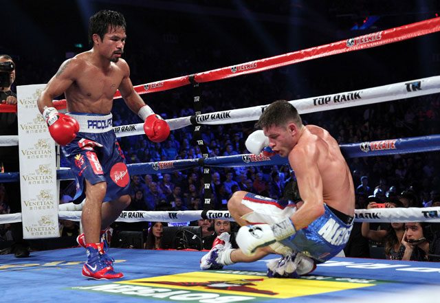 Manny Pacquiao looks on after knocking down Chris Algieri. File photo by Chris Farina/Top Rank