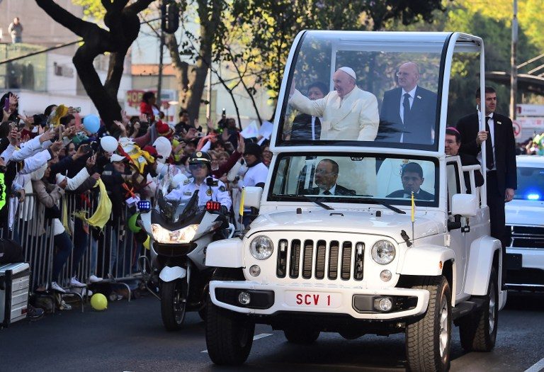 Pope Francis waves from the popemobile on his way to the National Palace. Ronaldo Schemidt/AFP 