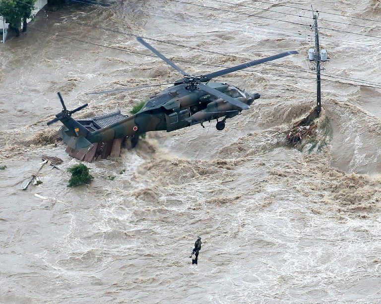Hundreds trapped as floods sweep Japan