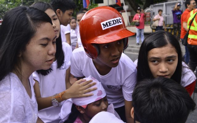 YOUNG RESPONDERS. Students from the General R. Papa High School in Taguig City assist their injured classmate to an emergency vehicle. Students along with their teachers participated in the city's earthquake drills in connection with the 2nd Metro Manila Shake Drill. Photo by Tessa Barre/ Rappler  
