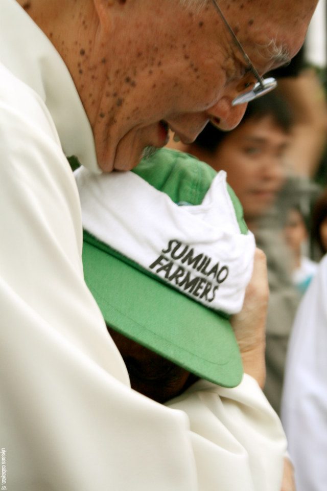 SHEPHERD'S EMBRACE. Then Manila Archbishop Gaudencio Cardinal Rosales embraces a farmer from Sumilao, Bukidnon, after the Sumilao farmers' 60-day march to fight for a 144-hectare piece of land. Photo courtesy of Ulysses Cabayao, SJ 