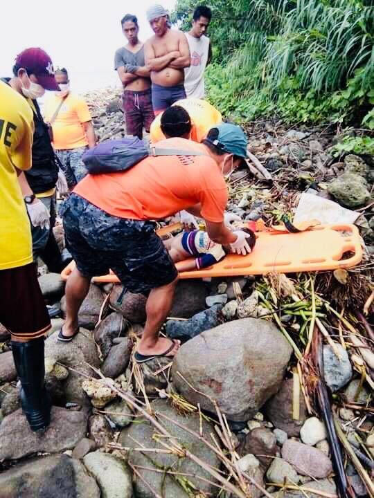 REVIVAL. Responders rescue a child from the landslide area in Patitinan, Sagñay, Camarines Sur. Photo courtesy of Radel Chavez Jr 