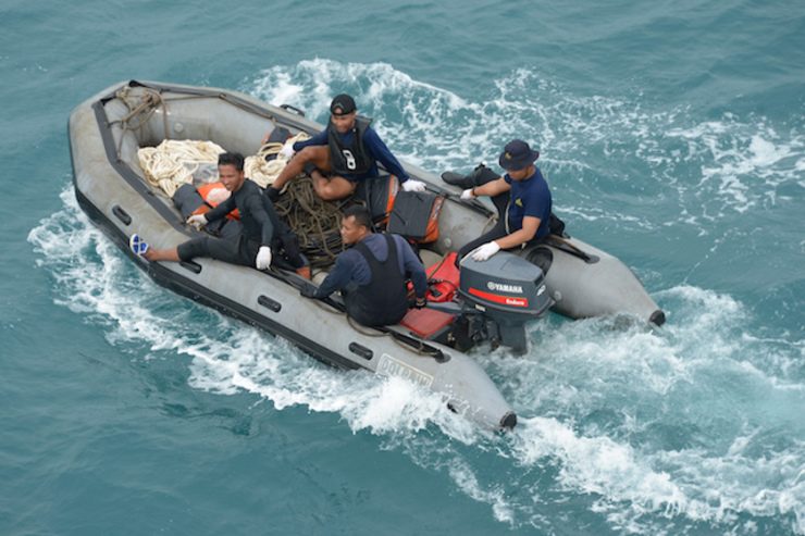 REWARDED. Indonesian navy divers on a boat after conducting operations to lift the tail of AirAsia flight QZ8501 from the sea bed on January 8, 2015. Photo from EPA