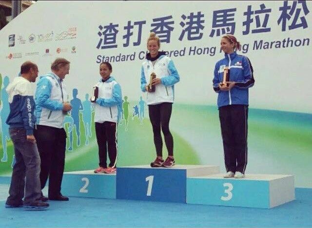 Mary Joy Tabal (L) stands stop the second place podium at the Hong Kong Marathon. Photo from Tabal's Facebook 