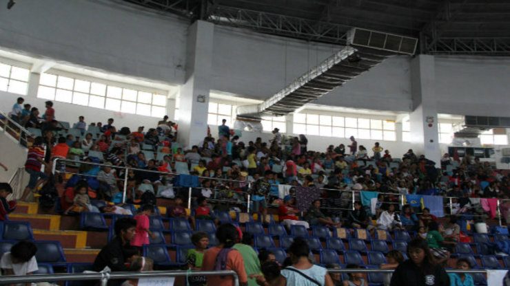 SHELTER. Families in Tacloban City evacuated to the city's astrodome. Photo from World Vision Philippines Facebook Page 