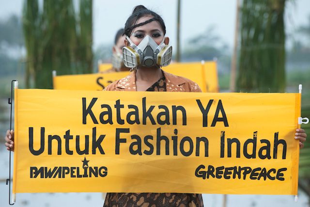 'Say YES to beautiful fashion', says the banner held by an Indonesian model. Photo handout by Greenpeace/Rappler 