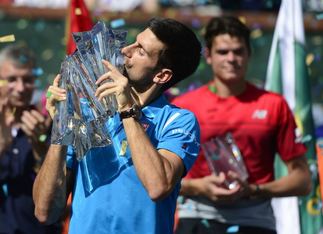 Djokovic routs hobbled Raonic to capture record 5th Indian Wells title