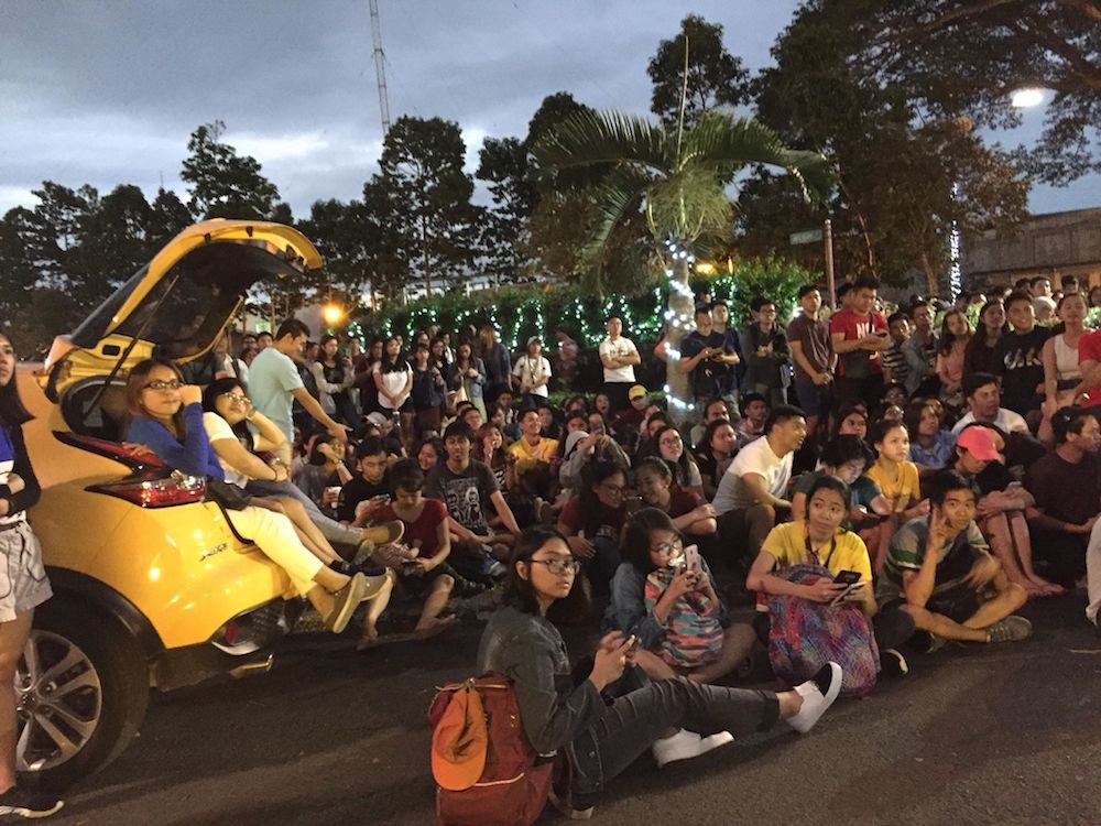 INTENSE. Students intensely watch the game at the Carabao Park in UP Los Baños. Photo by Derrick Ordoñez    