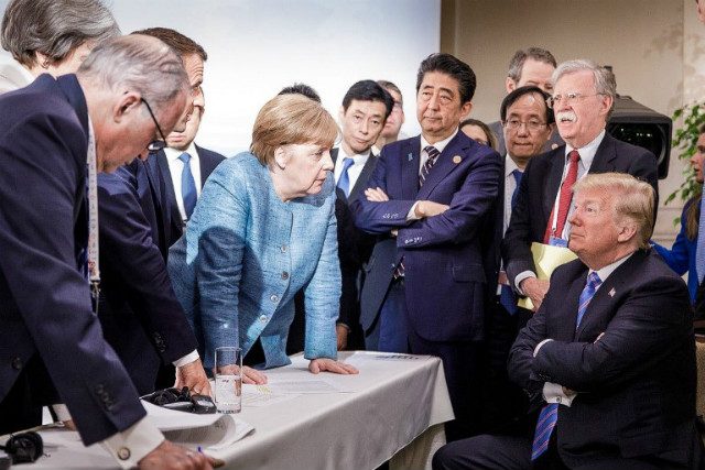 G7 SUMMIT. A photo released on Twitter by the German government's spokesman Steffen Seibert on June 9, 2018, and taken by the German government's photographer Jesco Denzel, shows US President Donald Trump (right) talking with German Chancellor Angela Merkel (center) and surrounded by other G7 leaders during a meeting of the G7 Summit in La Malbaie, Quebec, Canada. Photo by Jesco Denzel/Bundesregierung/AFP 