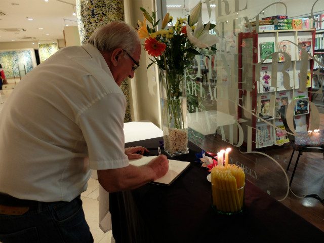 BOOK OF CONDOLENCES. Participants sign a book of condolences during a memorial service for victims of the Nice attack. Photo courtesy of the French embassy 