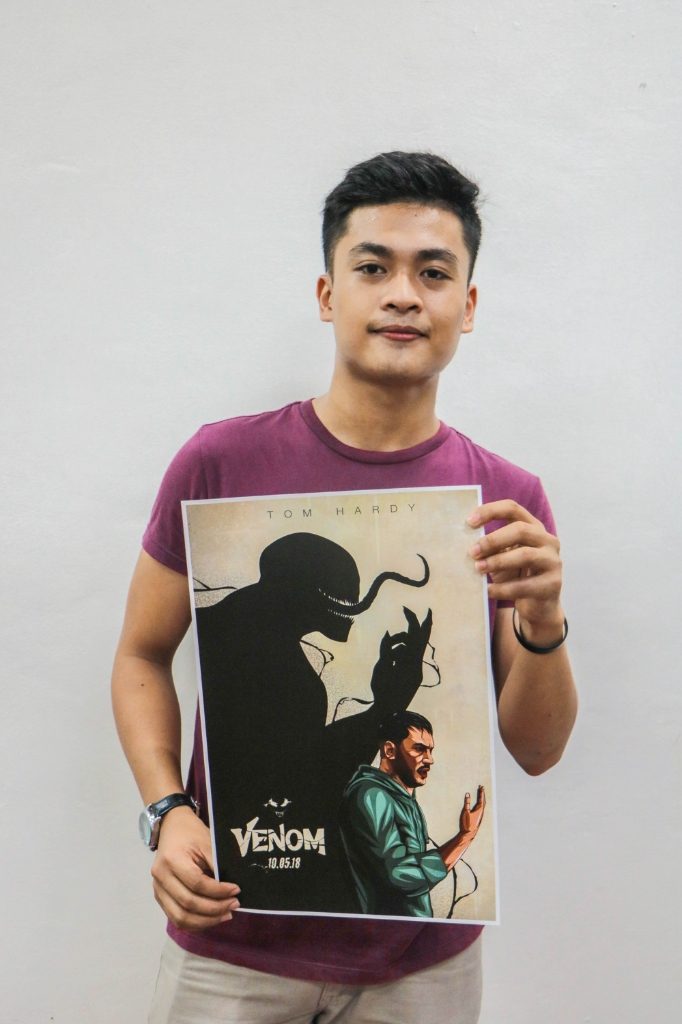 CONGRATS JEUZ! 22-year-old Jeuz Sumangil holding one of the five winning alternative 'Venom' posters. Photo courtesy of Columbia Pictures 