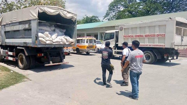FOOD FOR THE POOR. Truckloads of rice arrive at the Pampanga provincial capitol grounds for distribution to poor families in the province. Photo from Pampanga provincial governmentâs Facebook page 