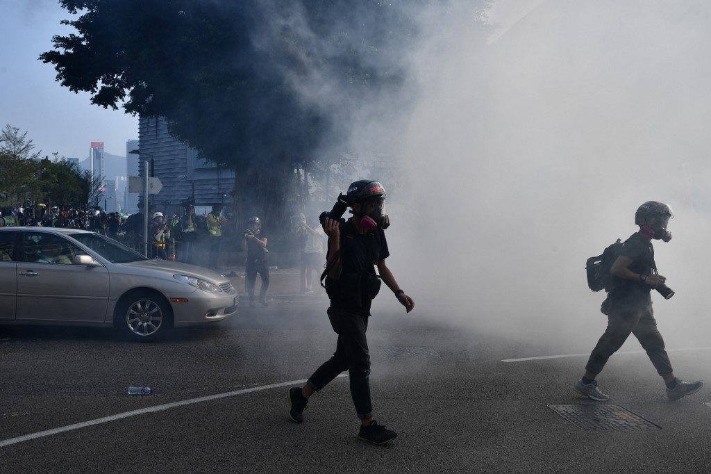 Hong Kong police fire tear gas at protesters on harborfront
