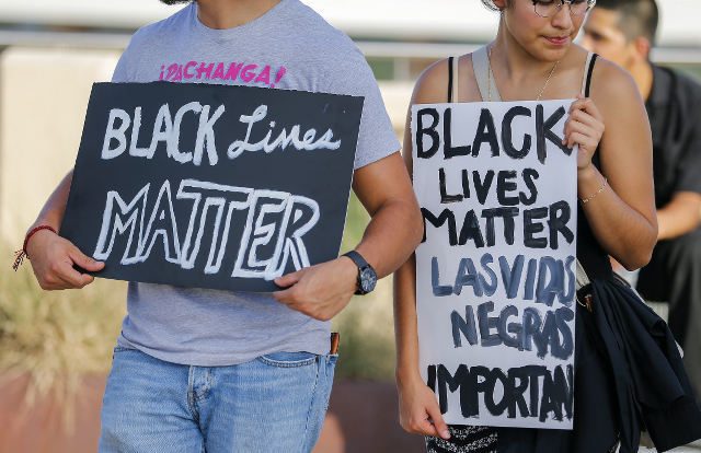 BLACK LIVES MATTER. A small group of Black Lives Matter protesters meet on the Ronald Kirk Pedestrian Bridge in Dallas, Texas, USA, July 10, 2016. Photo by Erik S. Lesser/EPA

 