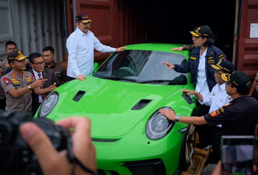 BUSTED. This handout photo taken on December 17, 201 shows Indonesia's Finance Minister Sri Mulyani Indrawati (top right) gesturing next to a seized luxury car during a raid in Jakarta. Handout /Indonesian Finance Ministry/AFP  