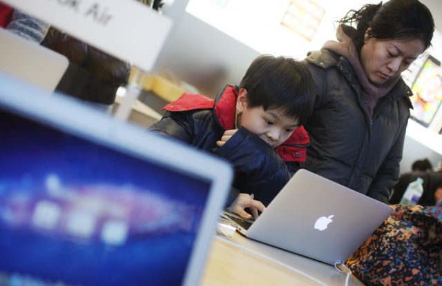 INFECTING MACBOOKS. A boy looks at content on a Macbook in an Apple store in Beijing, China, 10 January 2012. File Photo by How Hwee Young/EPA 