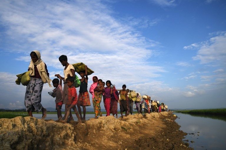 ABUSED. Rohingya Muslim refugees who were stranded after leaving Myanmar walk towards the Balukhali refugee camp after crossing the border in Bangladesh's Ukhia district on November 2, 2017. File photo by Dibyangshu Sarkar/AFP  