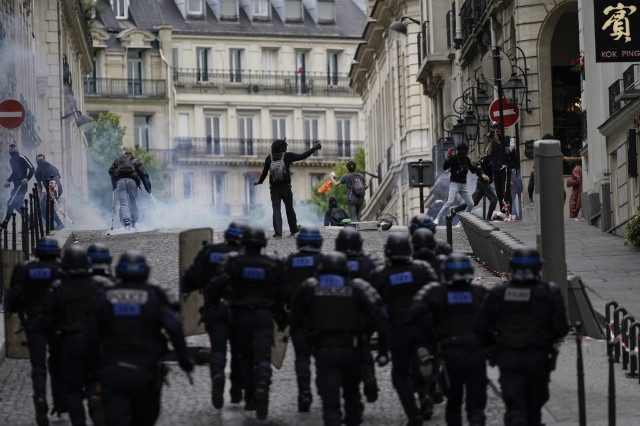 Paris protesters, police clash around Champs-Elysees after parade