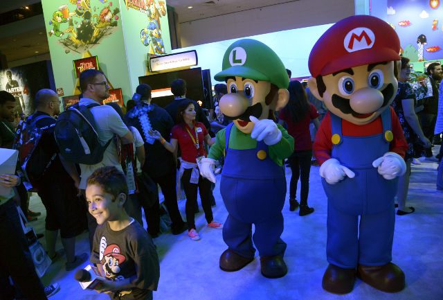 THE MARIO BROS. Mario Bros characters Mario (R) and Luigi walk the Nintendo floor at the E3 (Electronic Entertainment Expo) in Los Angeles, California, USA, June 16, 2015. Photo by Michael Nelson/EPA 