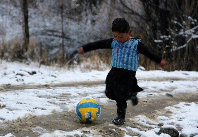 MESSI FAN. In this photograph taken on January 29, 2016, Afghan boy and Lionel Messi fan Murtaza Ahmadi, 5, wears a plastic bag jersey as he plays football in Jaghori district of Ghazni province. Photo by AFP 