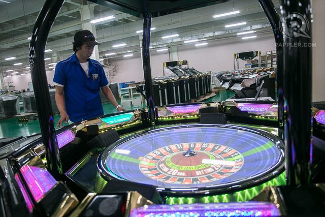 INSPECTING. A worker inspects Aruze's latest product, an electronic Roulette gaming table before shipping it out. It features a virtual display using 3D mapping instead of a physical Roulette wheel.  