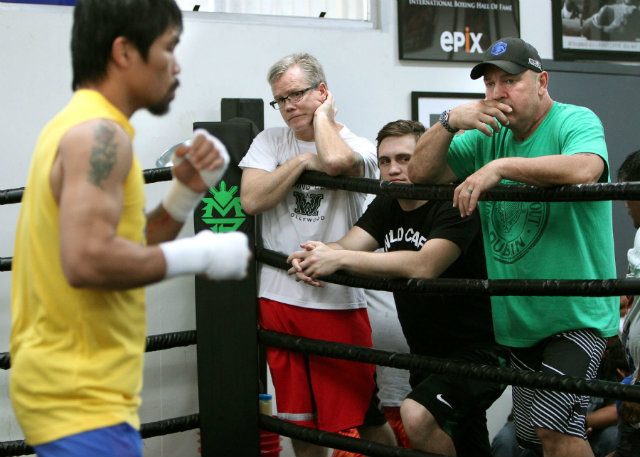 Manny Pacquiao shadowboxes as Freddie Roach, Liam Vaughnn and Justin Fortune look on. Photo by Chris Farina - Top Rank 